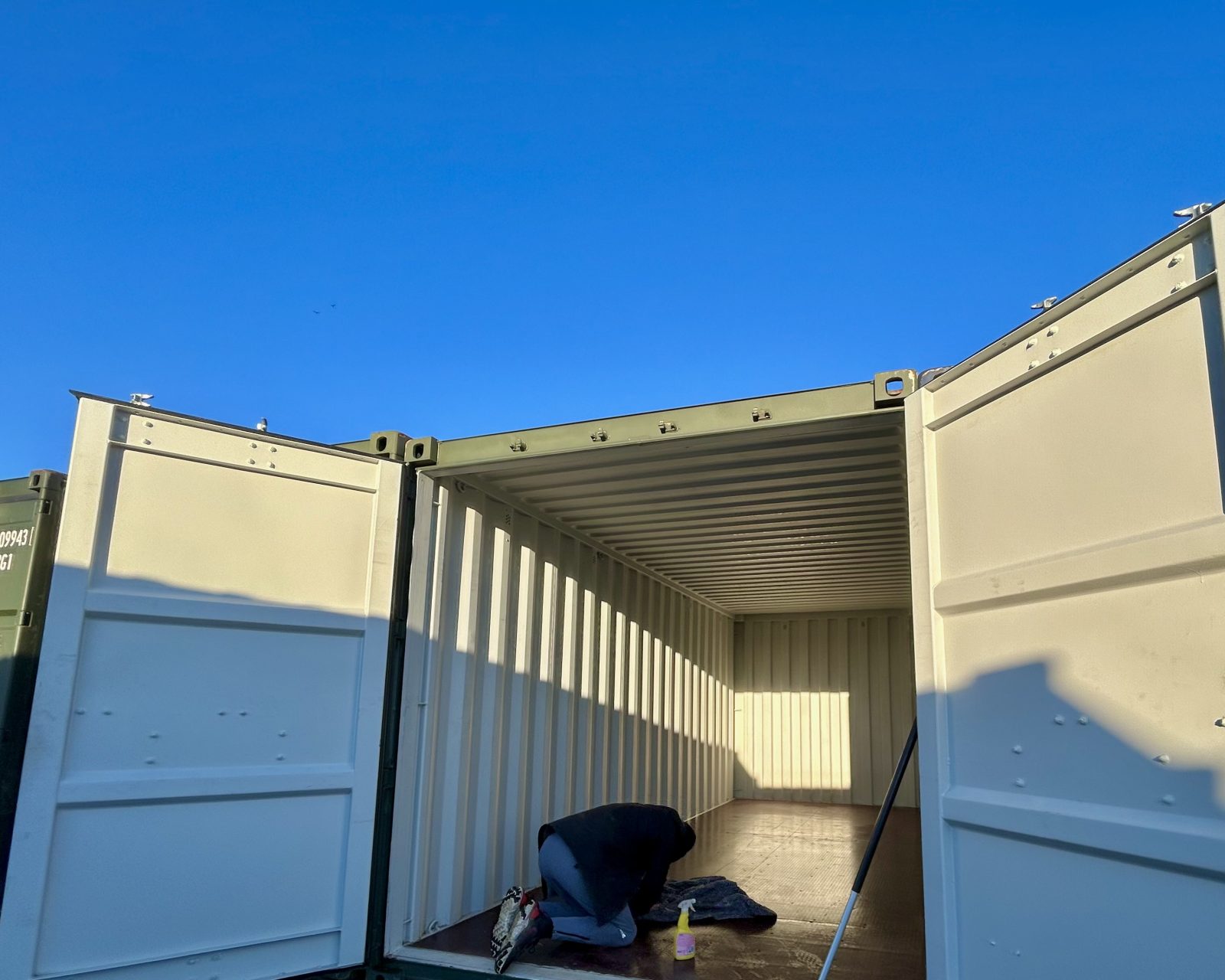 A person polishing the floor of a storage unit